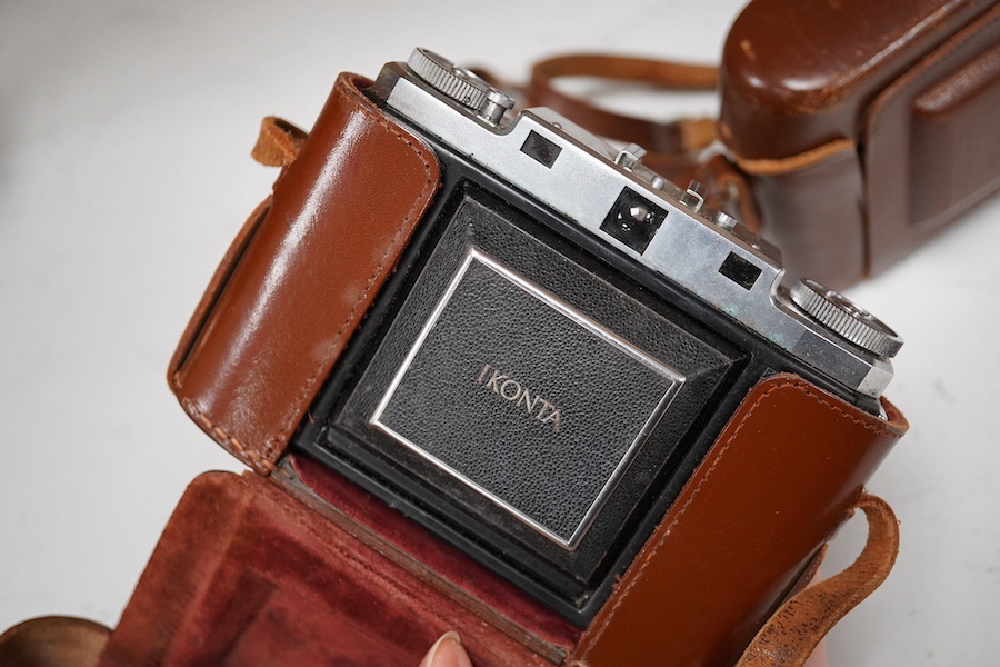 A Leica Model II camera in its original leather case, No. 204618, together with four additional cameras; a Zeiss Ikonta, a Zeiss Nettar, a Prinzflex 500E, and an Ensign Midget camera in its original card box with instruc